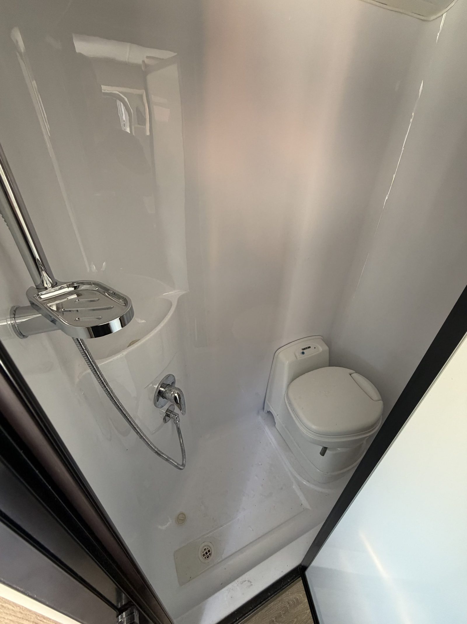 Compact kitchen with cooktop and sink in a Sahara motorhome